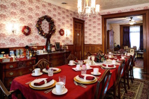 The dining room at Barristers B&B is set with a bright red table cloth, white plates and red napkins