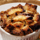 baked french toast in a white cup with baked pineapple on the side.